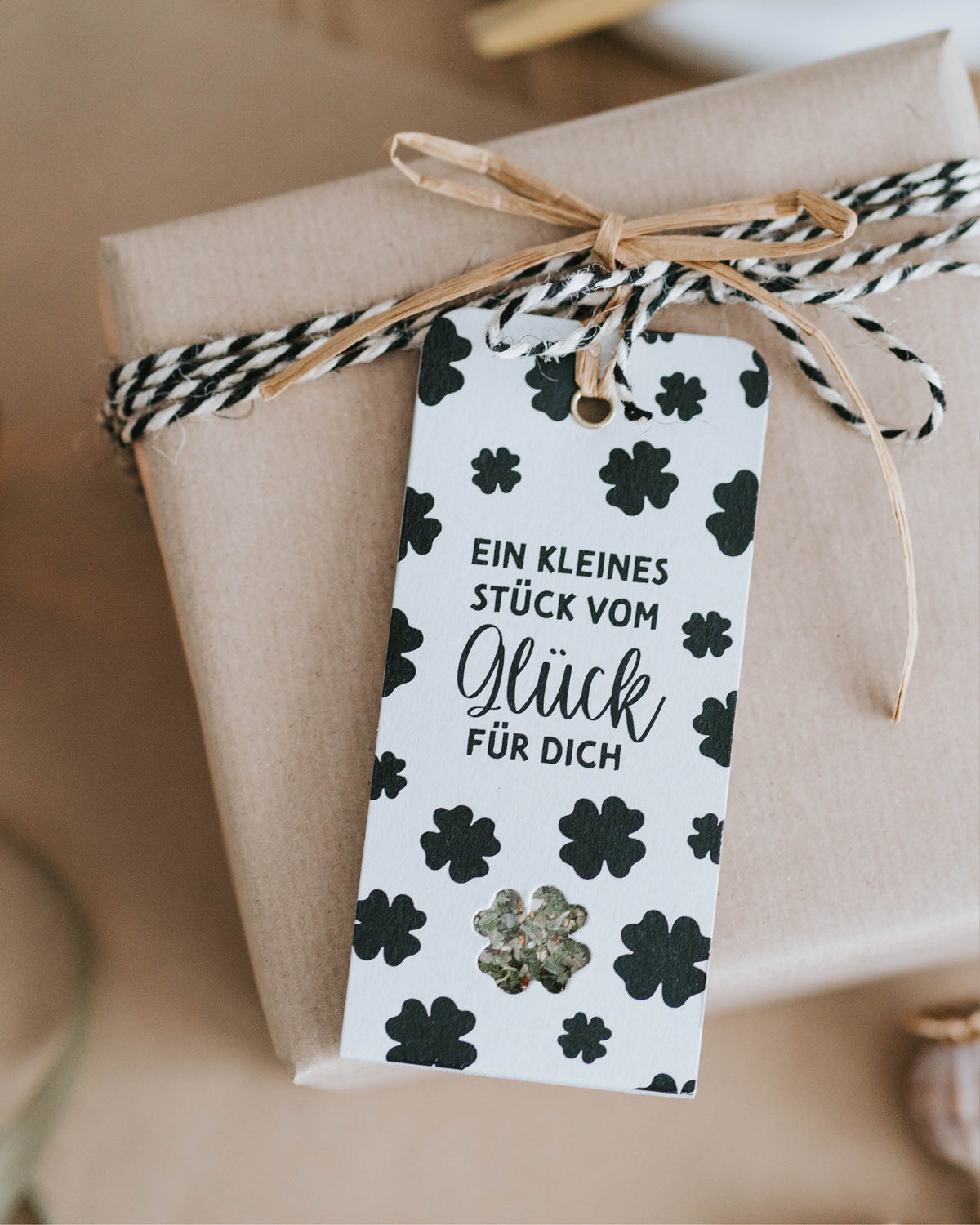 Geschenkanhänger mit Spruch „Ein kleines Stück vom Glück“ und bunter Salz-Blüten-Mischung.