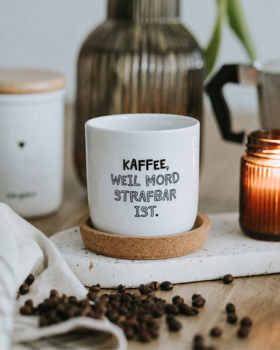 Porzellanbecher mit Spruch „Kaffee, weil Mord strafbar ist" in Schwarz-Weiß